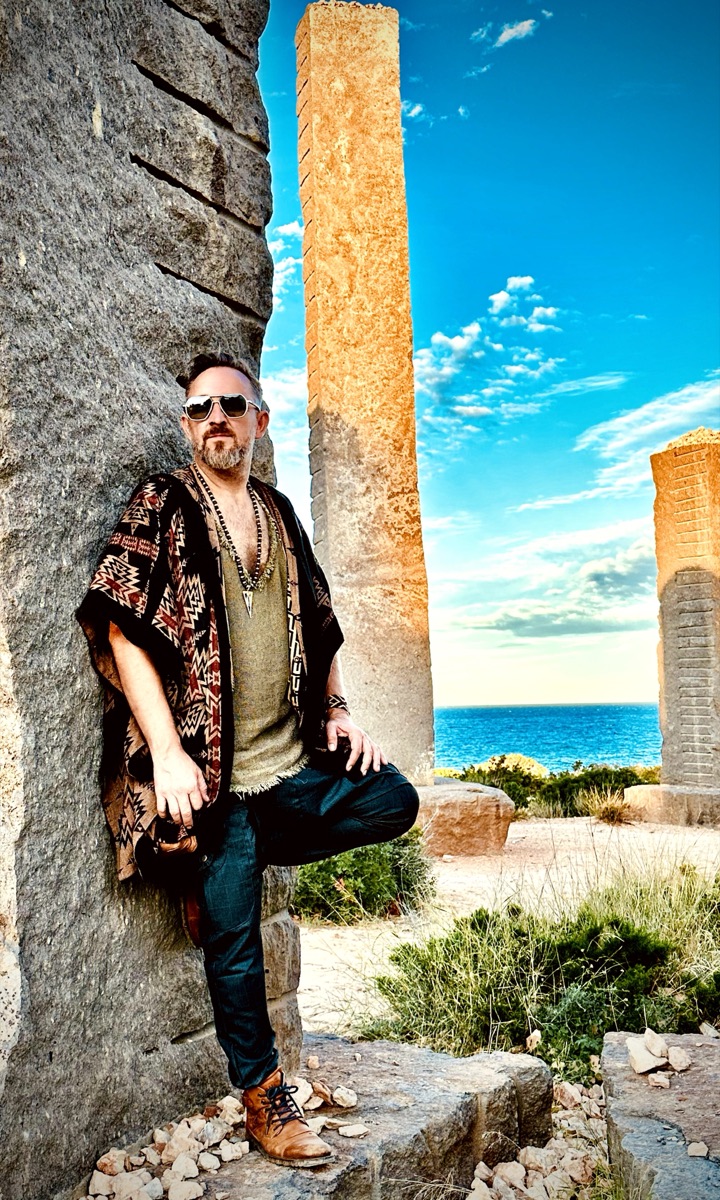Xaguar leaning against a stone pillar, Time & Space, Ibiza