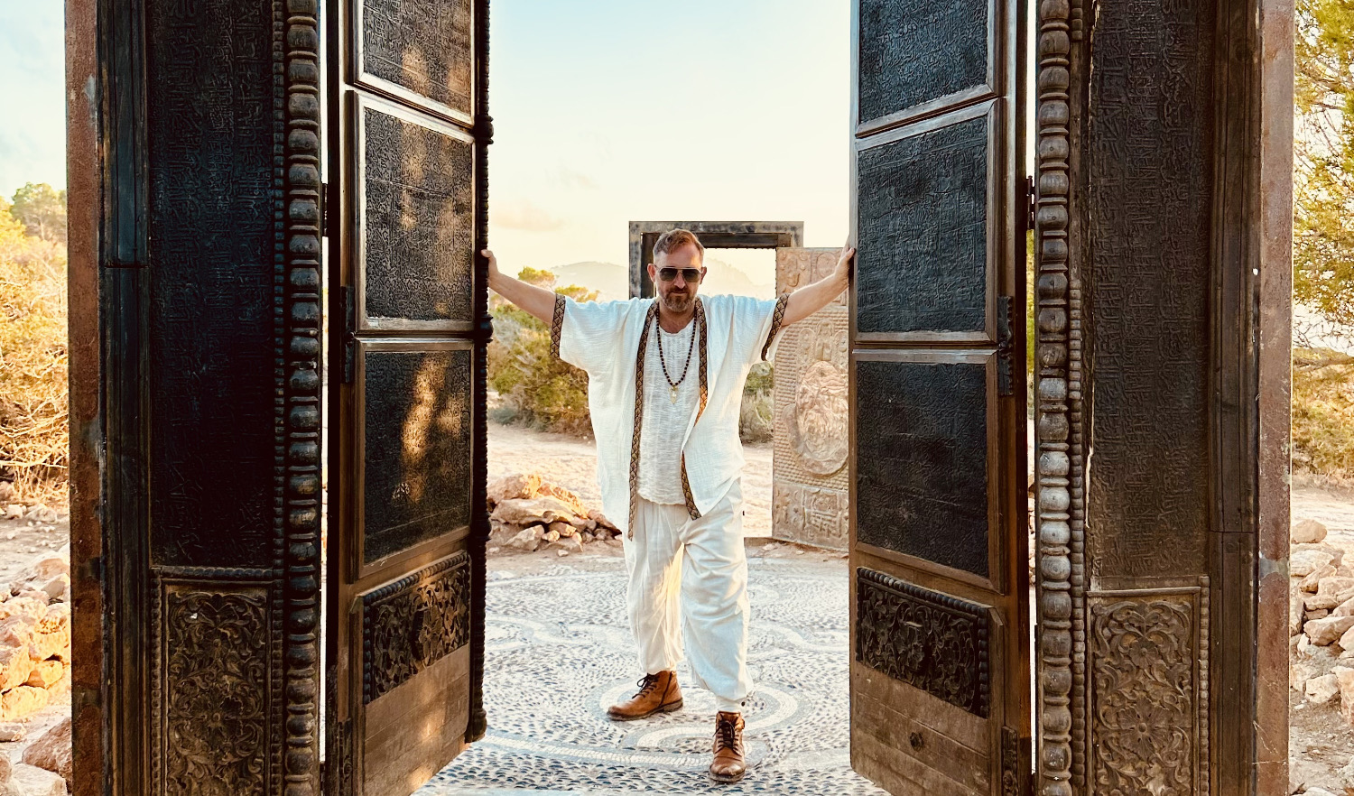 Xaguar standing in an open carved doorway, Ibiza